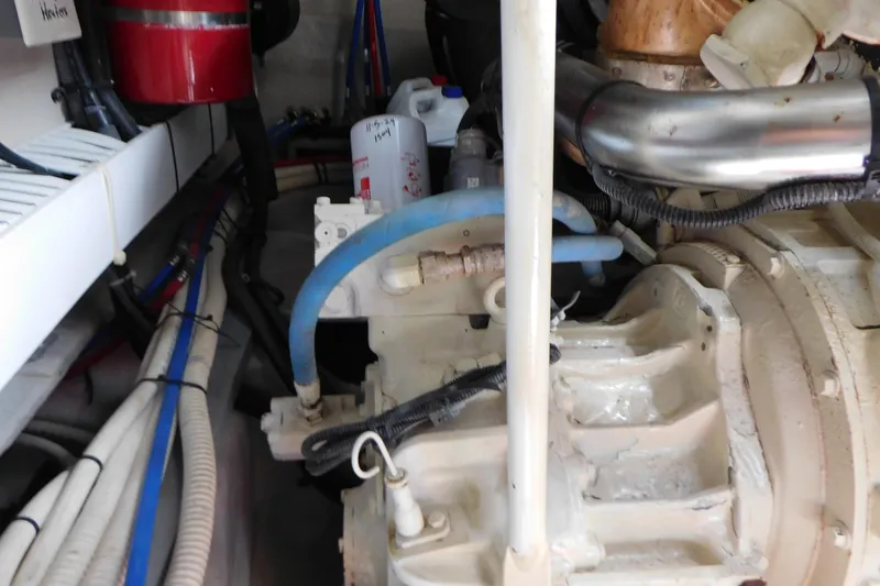 Slide: The Image of Engine room of a 2013 Sea Ray 510 Sundancer with visible hoses and components. - 86