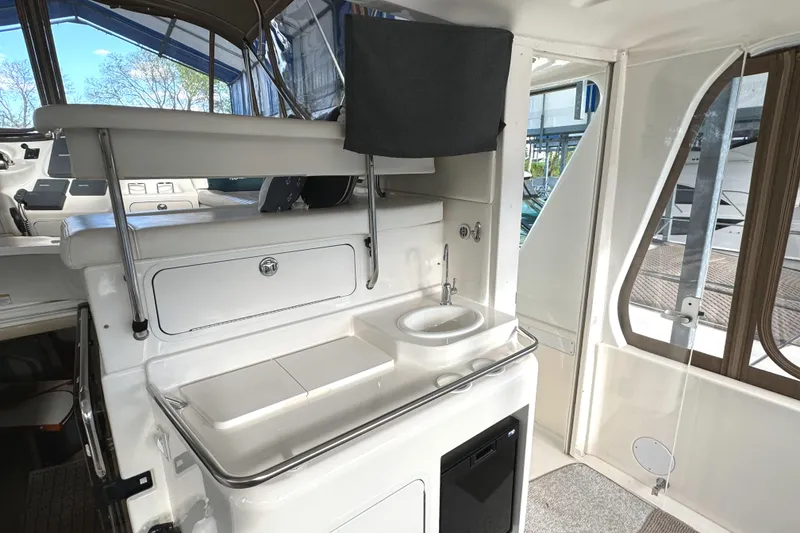 Slide: The Image of 2001 Sea Ray 420 Aft Cabin interior with sink and storage area. - 14