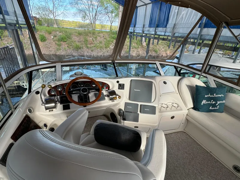 Slide: The Image of 2001 Sea Ray 420 Aft Cabin helm with plush seating and panoramic windows. - 18