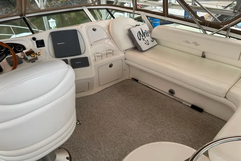 Slide: The Image of Luxurious interior of 2001 Sea Ray 420 Aft Cabin yacht with plush seating and helm. - 20