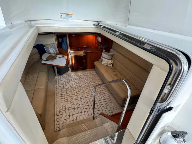Slide: The Image of Interior of 2001 Sea Ray 420 Aft Cabin yacht, featuring cozy seating and elegant wood finishes. - 31