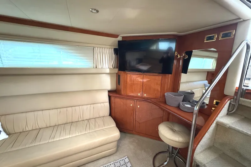 Slide: The Image of Luxurious interior of 2001 Sea Ray 420 Aft Cabin yacht with TV and seating area. - 33