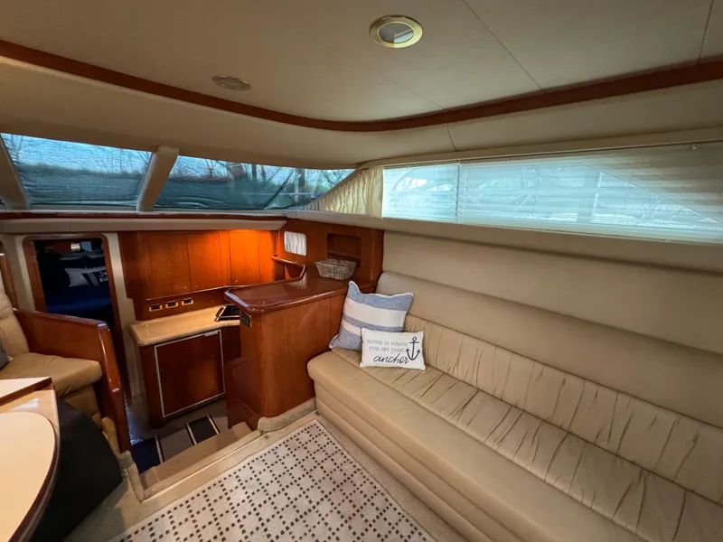 Slide: The Image of Luxurious interior of 2001 Sea Ray 420 Aft Cabin yacht with cozy seating and elegant wood finishes. - 35