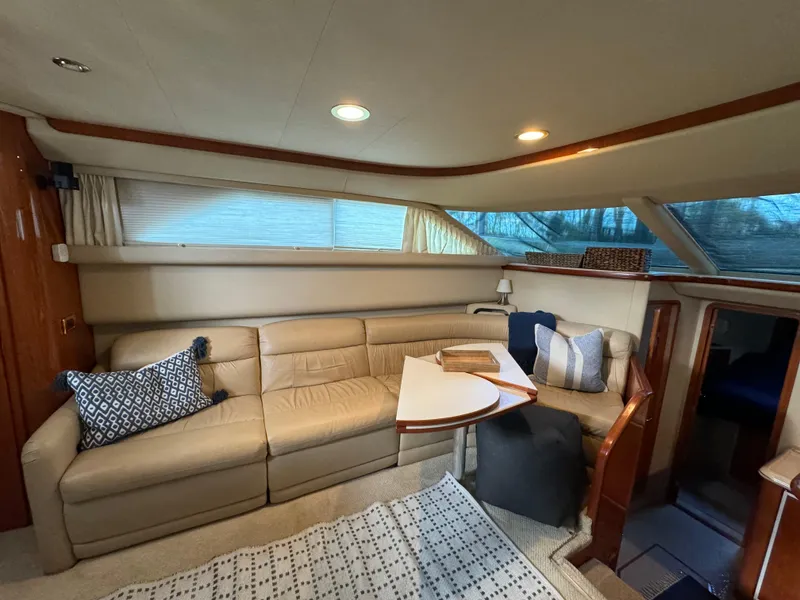 Slide: The Image of Luxurious interior of 2001 Sea Ray 420 Aft Cabin with beige leather seating. - 37