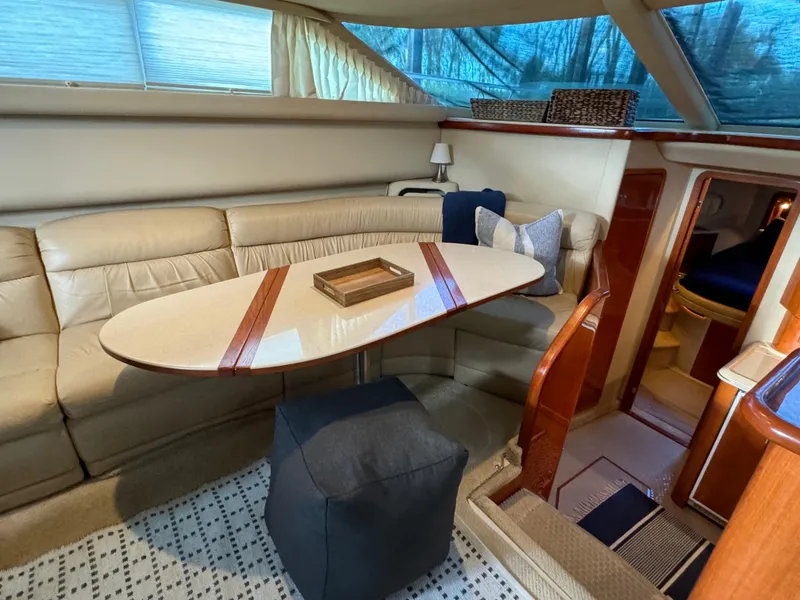 Slide: The Image of Interior of 2001 Sea Ray 420 Aft Cabin with elegant seating and dining area. - 38