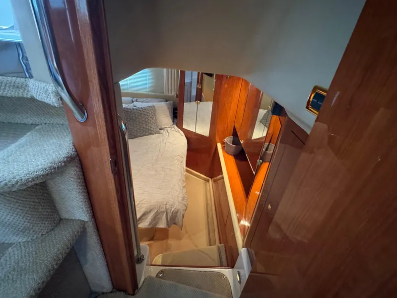 Slide: The Image of Interior of 2001 Sea Ray 420 Aft Cabin with cozy bedroom and wooden finishes. - 40