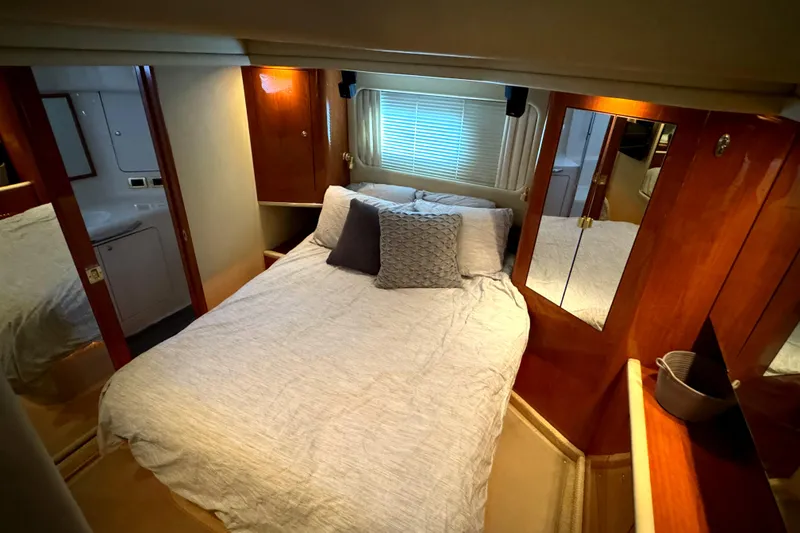 Slide: The Image of Luxurious bedroom in 2001 Sea Ray 420 Aft Cabin yacht with cozy bedding and wooden accents. - 41