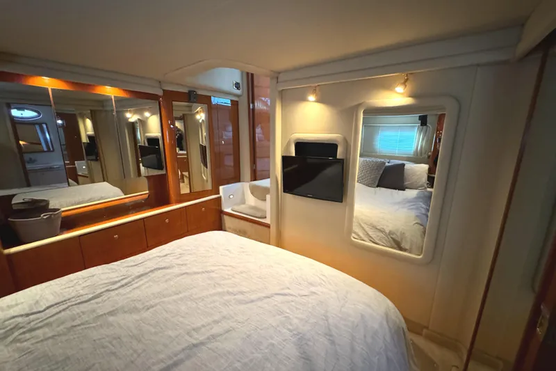 Slide: The Image of Luxurious 2001 Sea Ray 420 Aft Cabin bedroom with mirrors and cozy bedding. - 42