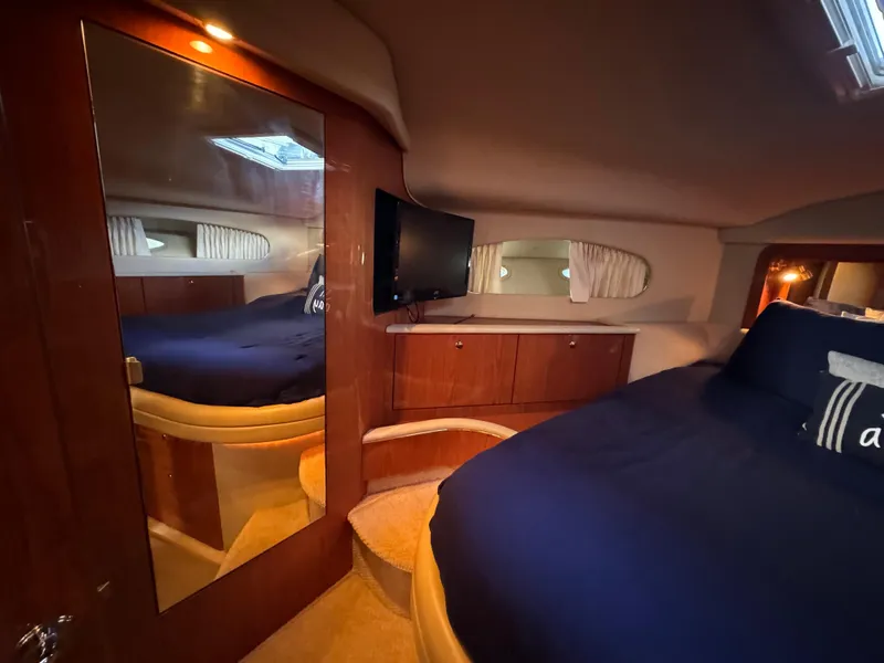 Slide: The Image of Luxurious 2001 Sea Ray 420 Aft Cabin interior with cozy bed and elegant wood finishes. - 58