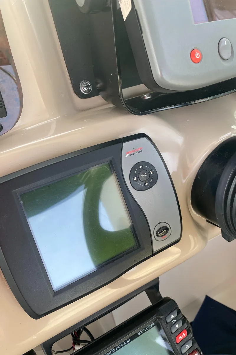 Slide: The Image of Control panel of a 2005 Sea Ray 300 Sundancer boat with navigation equipment. - 11