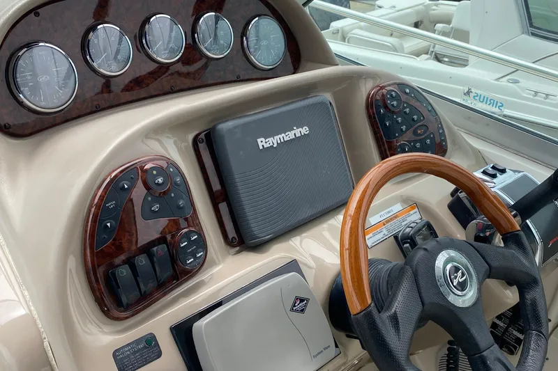 Slide: The Image of Dashboard of a 2005 Sea Ray 300 Sundancer with Raymarine navigation system. - 24