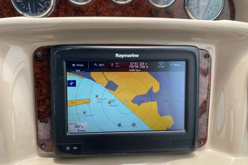 Slide: The Image of Raymarine navigation system on 2005 Sea Ray 300 Sundancer boat dashboard. - 26