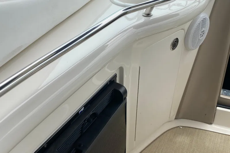 Slide: The Image of Interior detail of a 2005 Sea Ray 300 Sundancer boat, featuring a speaker and railing. - 27