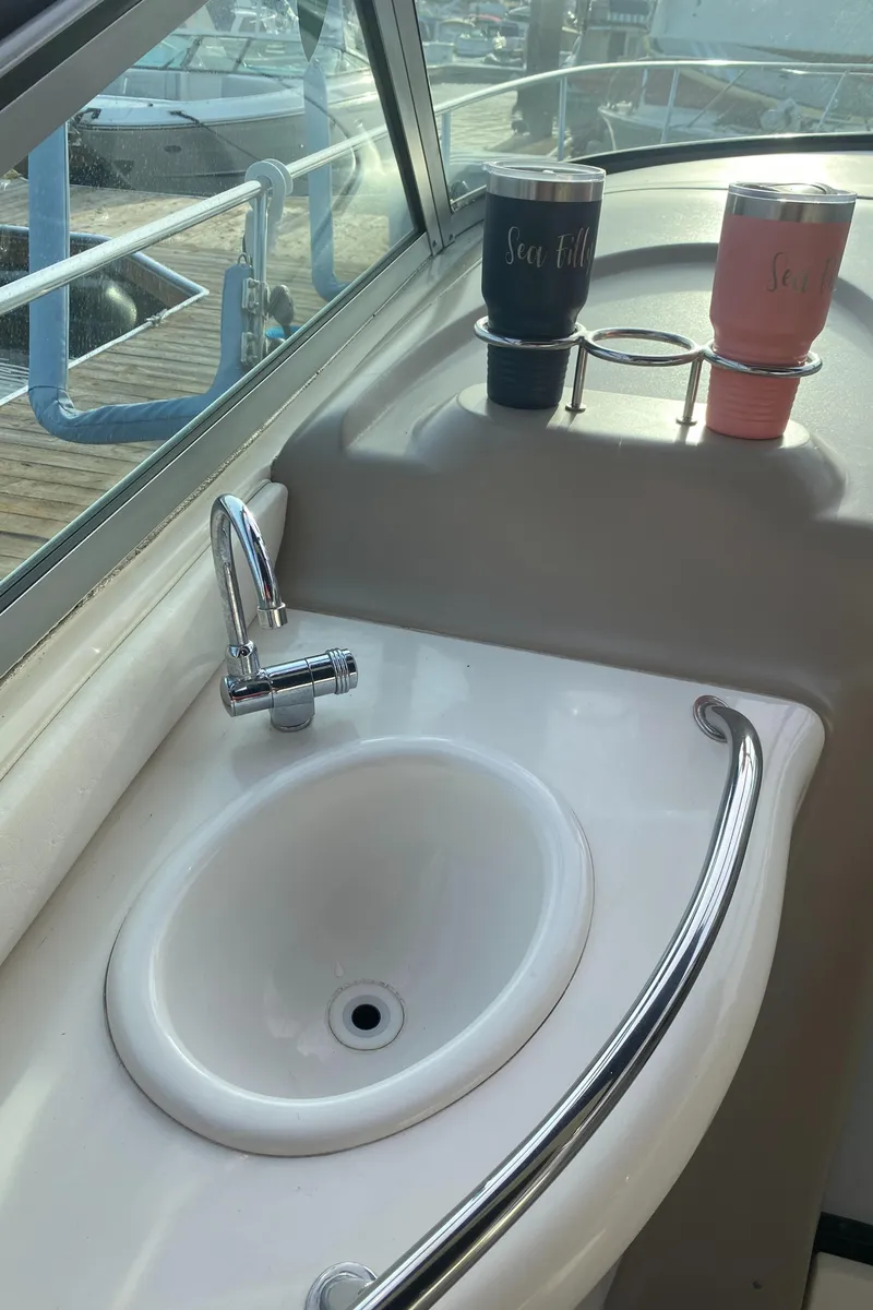Slide: The Image of 2005 Sea Ray 300 Sundancer boat sink with cup holders on deck. - 5