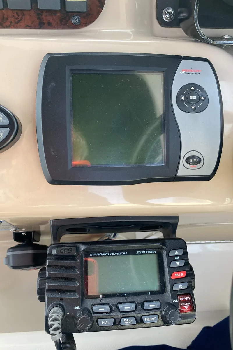 Slide: The Image of Control panel of a 2005 Sea Ray 300 Sundancer boat with navigation equipment. - 7