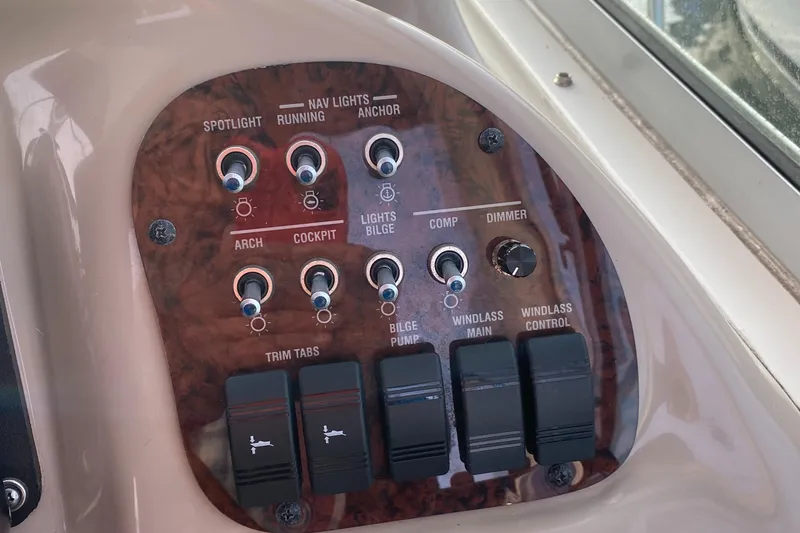 Slide: The Image of Control panel of a 2005 Sea Ray 300 Sundancer boat with various switches. - 8
