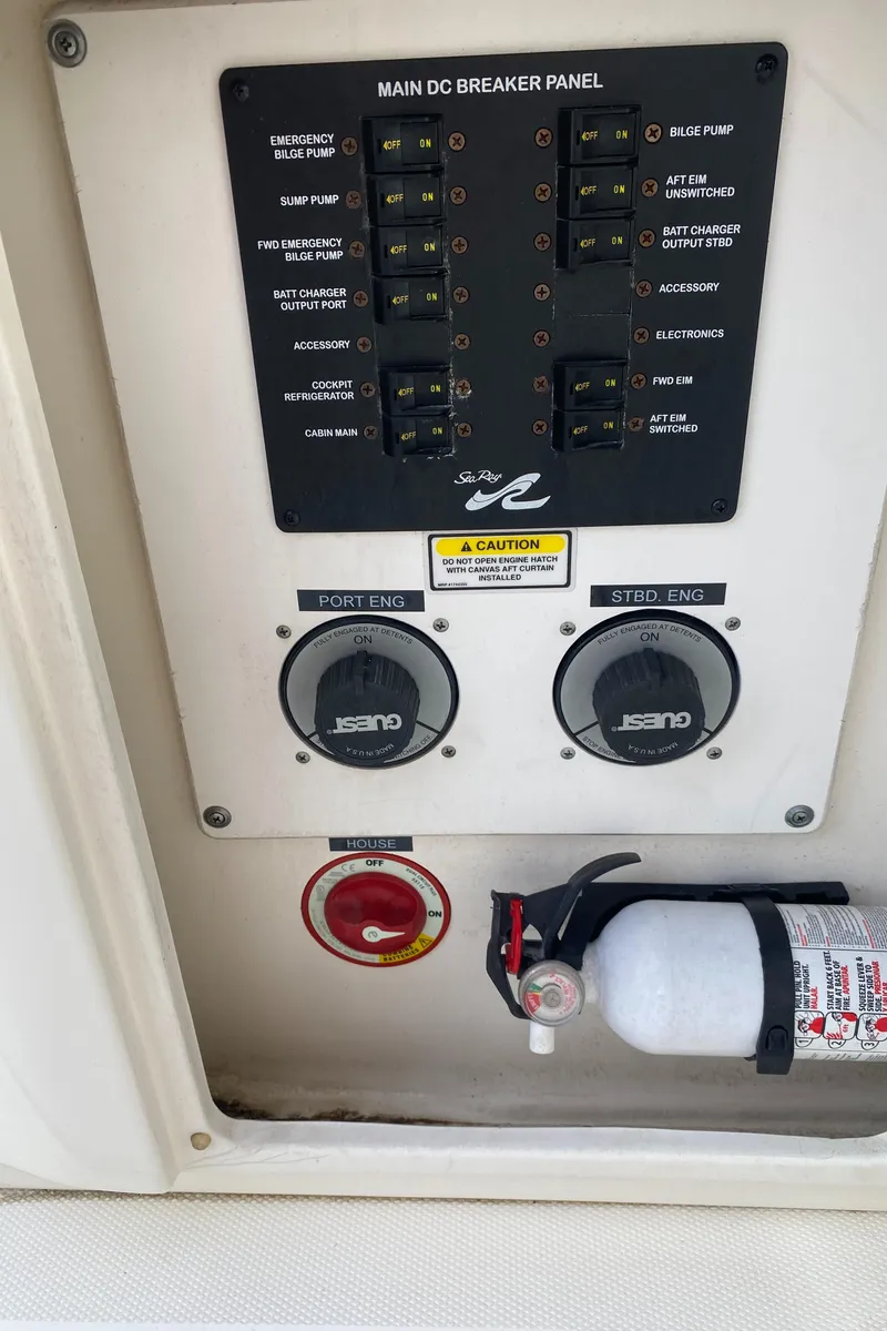 Slide: The Image of Main DC breaker panel on 2005 Sea Ray 300 Sundancer with fire extinguisher. - 9