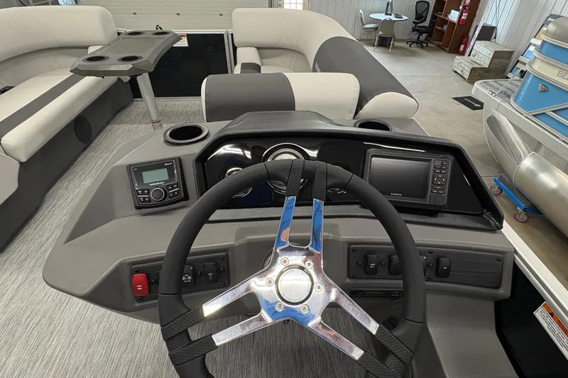 Slide: The Image of Interior view of 2026 Bennington 22 SSR Stern Radius SNAP boat, featuring steering wheel and control panel. - 13