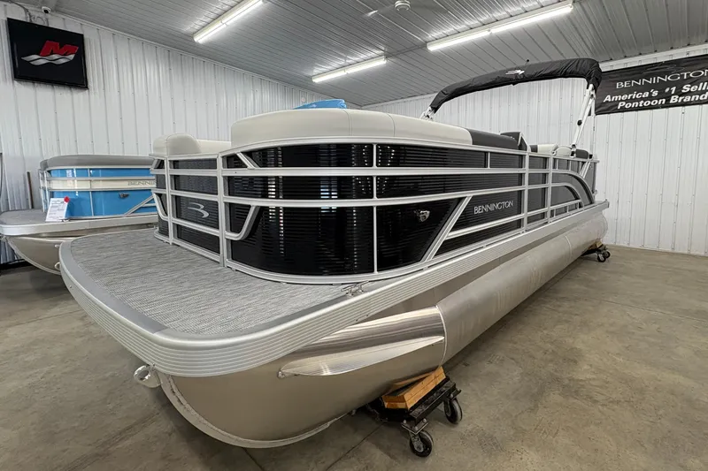 Slide: The Image of 2026 Bennington 22 SSR Stern Radius SNAP pontoon boat in showroom. - 2