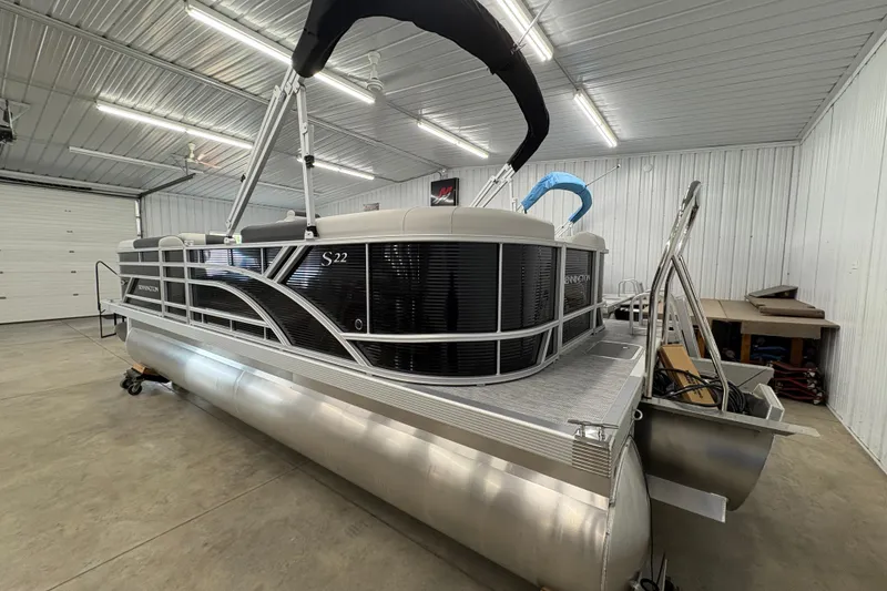 Slide: The Image of 2026 Bennington 22 SSR Stern Radius SNAP pontoon boat in a spacious indoor garage. - 3