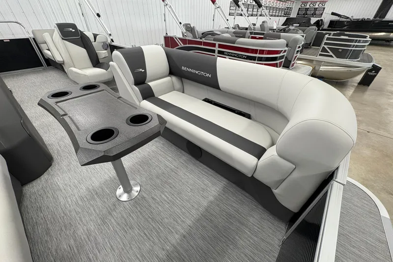 Slide: The Image of 2026 Bennington 22 SSR Stern Radius SNAP pontoon boat interior with plush seating and table. - 6