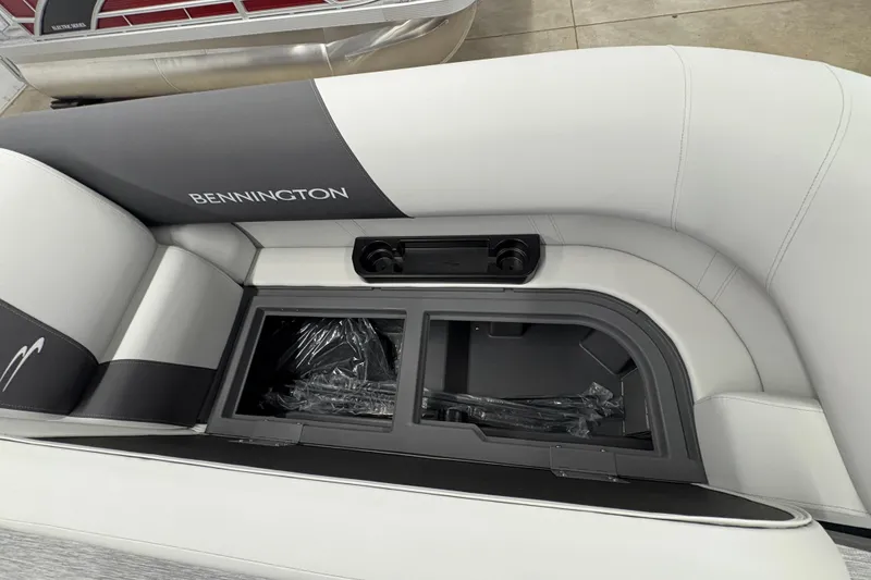 Slide: The Image of 2026 Bennington 22 SSR Stern Radius SNAP boat seat with storage compartment open. - 7