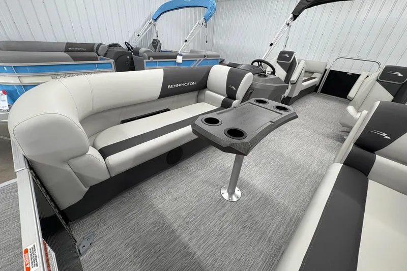 Slide: The Image of 2026 Bennington 22 SSR Stern Radius SNAP pontoon boat interior with seating and table. - 9