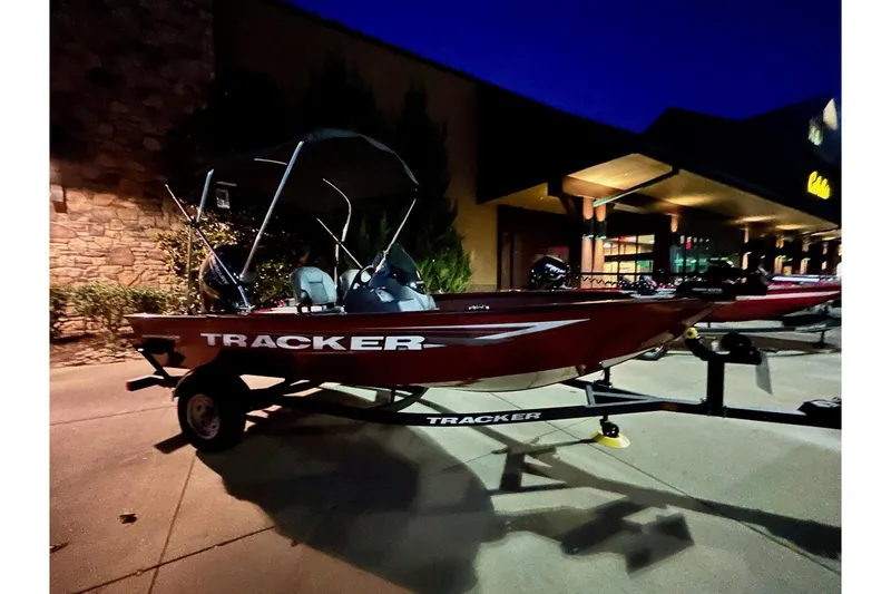 Slide: The Image of 2026 Tracker Super Guide V-16 SC boat on trailer at night, parked outside a building. - 10
