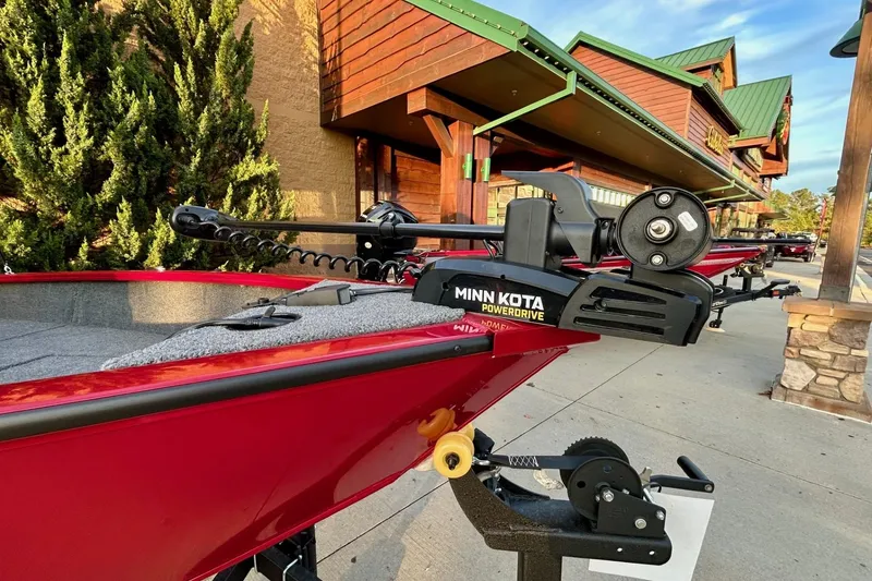 Slide: The Image of Red 2026 Tracker Super Guide V-16 SC boat with Minn Kota PowerDrive motor. - 4