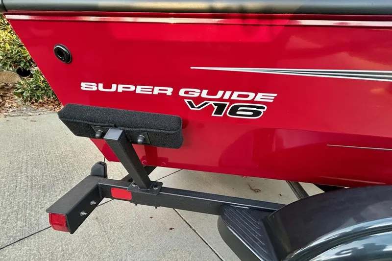Slide: The Image of Red 2026 Tracker Super Guide V-16 SC boat on trailer, side view. - 5