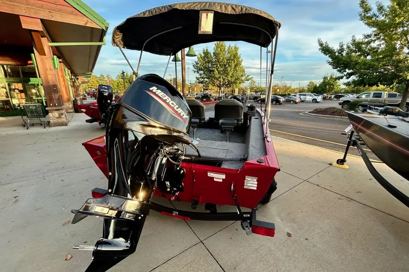 Slide: The Image of 2026 Tracker Super Guide V-16 SC boat with Mercury engine, parked outdoors. - 6