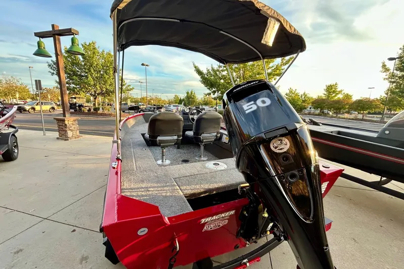 Slide: The Image of 2026 Tracker Super Guide V-16 SC boat with Mercury 50 engine, parked outdoors. - 8