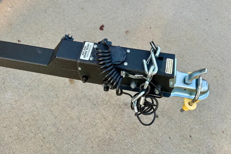 Slide: The Image of Trailer hitch of 2026 Tracker Super Guide V-16 SC on concrete surface. - 9