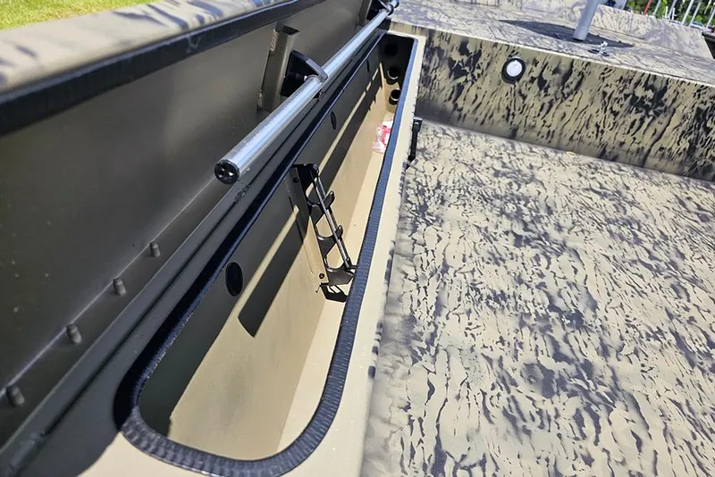Slide: The Image of 2026 Tracker Grizzly 1654 T Sportsman boat interior with camouflage design and storage compartment. - 11