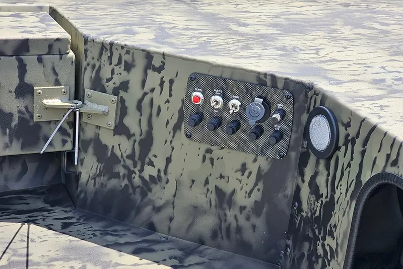 Slide: The Image of Control panel of 2026 Tracker Grizzly 1654 T Sportsman boat with camouflage design. - 12