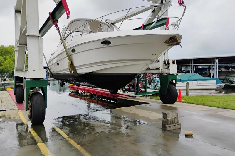The Image of 2007 Regal 3760 IB Commodore yacht being lifted at a marina. - 0