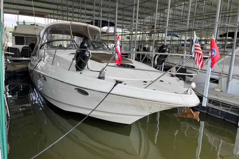 Slide: The Image of 2007 Regal 3760 IB Commodore yacht docked with flags displayed. - 1