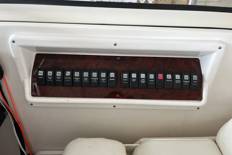 Slide: The Image of Control panel of a 2007 Regal 3760 IB Commodore boat with labeled switches. - 14