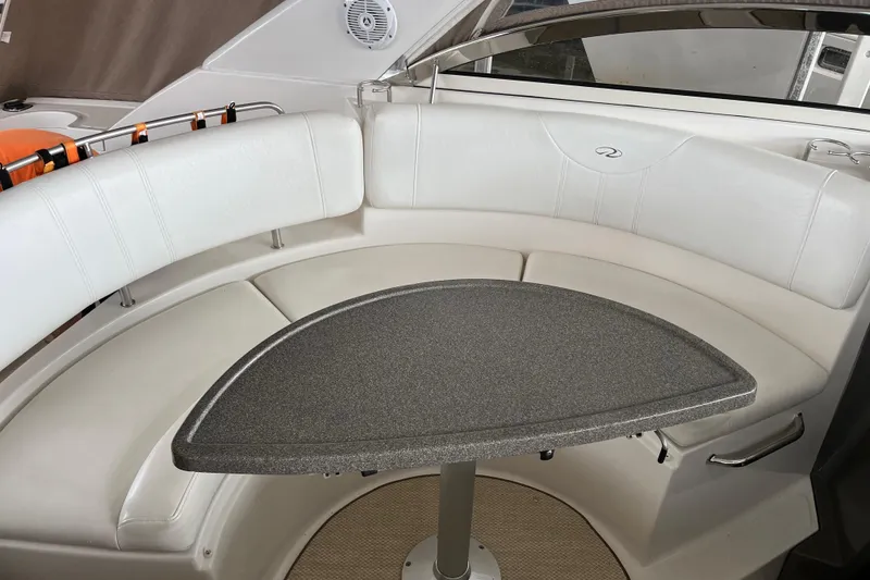 Slide: The Image of 2007 Regal 3760 IB Commodore boat interior with white seating and triangular table. - 21