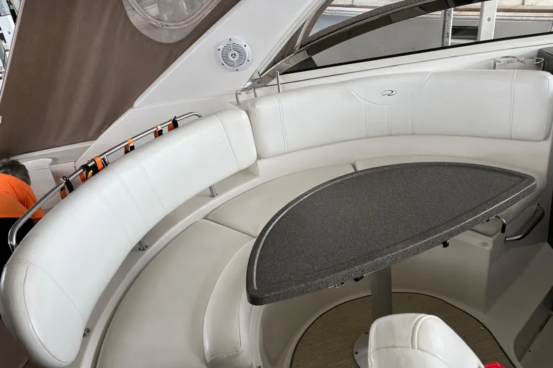 Slide: The Image of 2007 Regal 3760 IB Commodore boat interior with white seating and a curved table. - 22