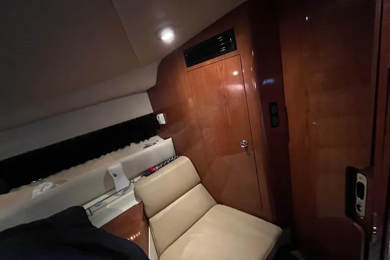 Slide: The Image of Interior of 2007 Regal 3760 IB Commodore yacht with wooden paneling and beige seating. - 27
