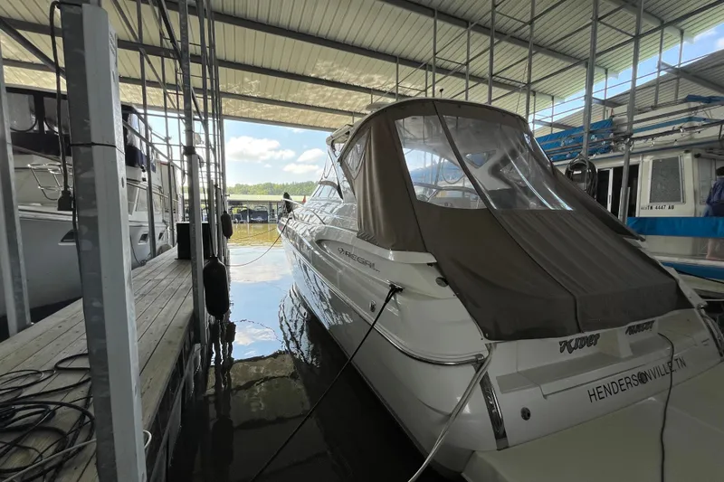 Slide: The Image of 2007 Regal 3760 IB Commodore docked in a covered marina. - 3