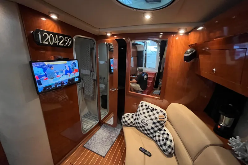 Slide: The Image of Interior of 2007 Regal 3760 IB Commodore yacht with TV, seating, and wood paneling. - 30