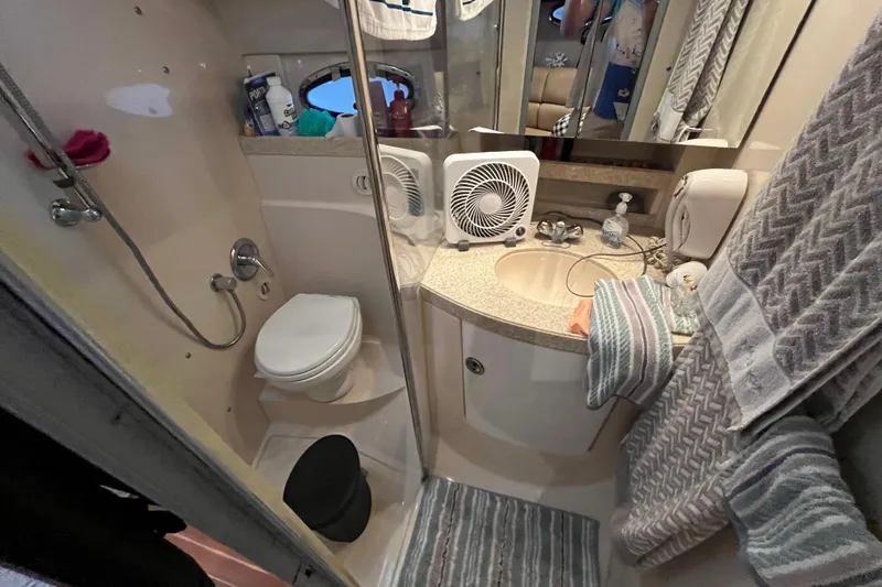 Slide: The Image of Bathroom interior of 2007 Regal 3760 IB Commodore yacht, featuring shower, toilet, and sink. - 31