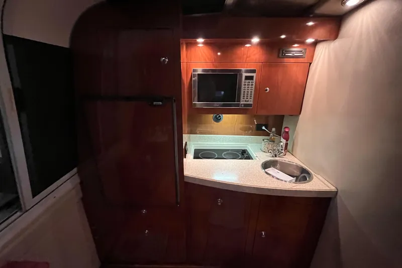 Slide: The Image of 2007 Regal 3760 IB Commodore yacht kitchen with microwave, stove, and sink. - 37