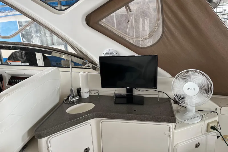 Slide: The Image of 2007 Regal 3760 IB Commodore interior with TV, fan, and sink on countertop. - 9