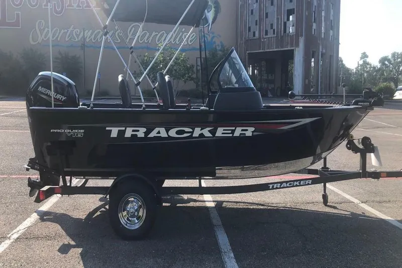 Slide: The Image of 2026 Tracker Pro Guide V-16 WT boat on trailer in parking lot. - 5