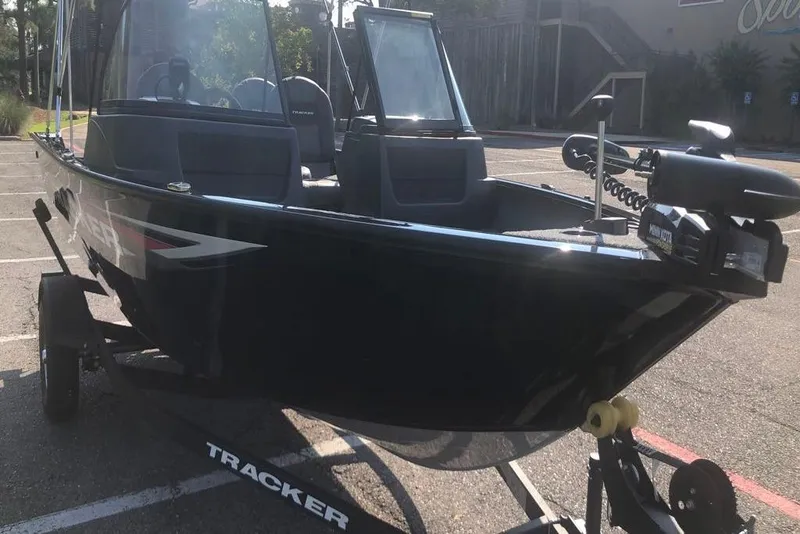 Slide: The Image of 2026 Tracker Pro Guide V-16 WT boat on trailer in parking lot. - 6