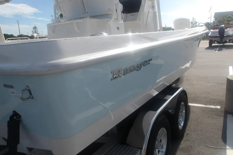 Slide: The Image of 2025 Ranger 2360 Bay boat on trailer, showcasing sleek design and branding. - 5