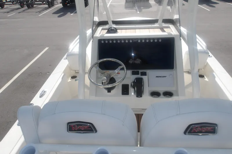 Slide: The Image of 2025 Ranger 2360 Bay boat dashboard with steering wheel and Mercury controls. - 14